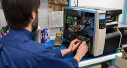 Maintenance being performed on a Thermal Transfer Printer.